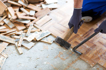 Hammer, crowbar and a pile of old flooring shot all together on the construction site