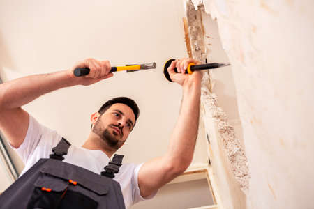 Joined forces of a handyman and his tools in construction work action
