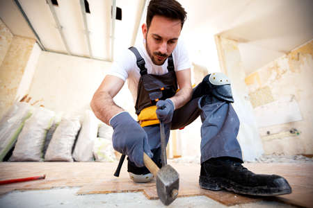 Just making place for new parquet with hammer, crowbar and hard workの写真素材