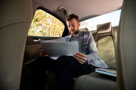 Young entrepreneur checking business papers because there is no margin for errors