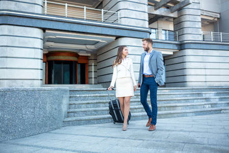 Handsome man accompanying his lovely girl as she goes traveling