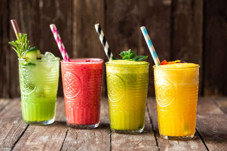 Various delicious and tasty smoothies aligned in order on the table, raw food concept