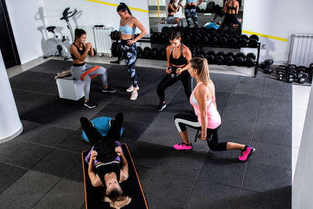 Group of women doing leg workouts in the gym