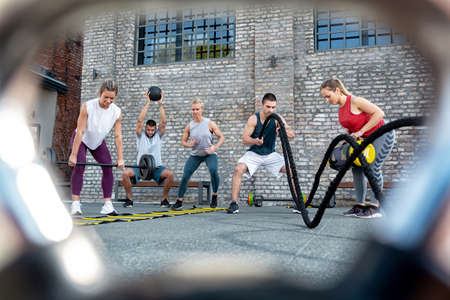 Workout seen through the handle of a kettlebell, fitness concept