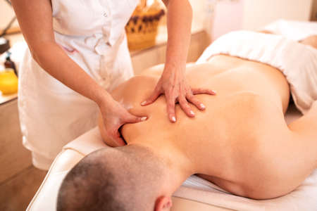 Muscular man having a massage, concept of body massage therapyの写真素材