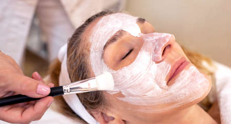 Facial skin repair and rejuvenation mask applied in a beauty salon