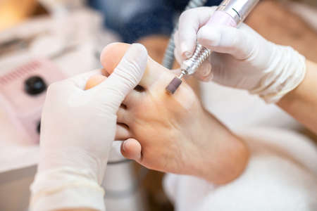 Foot pedicure treatment,  big toe skin area, rotating skin pedicure fileの写真素材