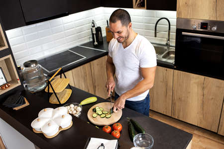 Young cook preparing the ingredients for a tasty meal he is about to start making in his home...