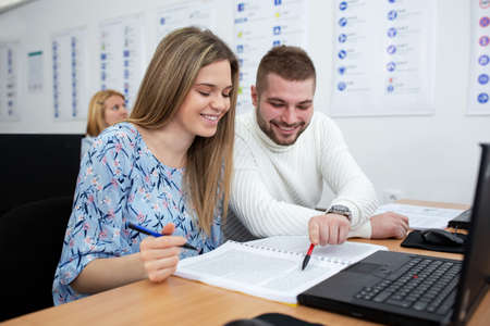 Young woman and a young man sitting in class, student concept