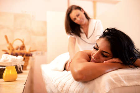 Masseuse and her client in beauty salon, massage conceptの写真素材