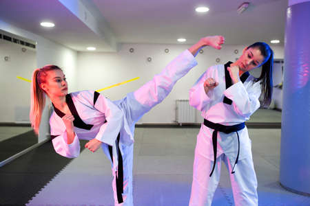 Two martial artists preparing for the competition and training hard