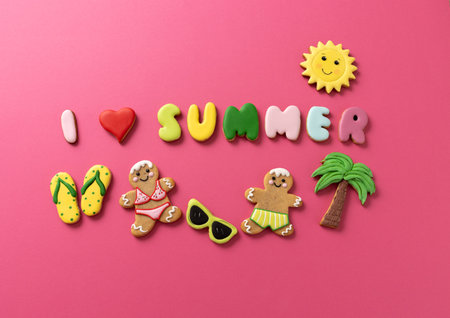Gingerbread man and gingerbread woman summer cookies, i love summer cookies theme, pink background conceptの写真素材