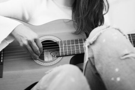 Detail of a singer girl playing the guitarの写真素材