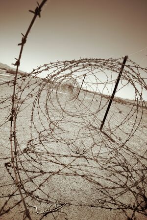 barbed wire at the border of a mine field