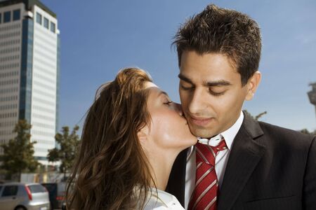 two colleagues kissing each other during a break from workの写真素材