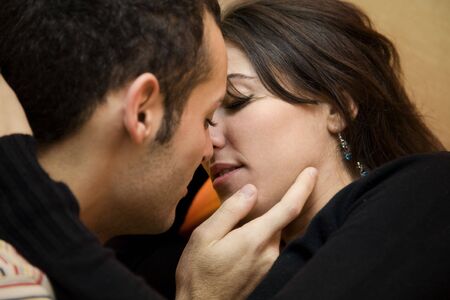 portrait of a young couple kissing and hugging