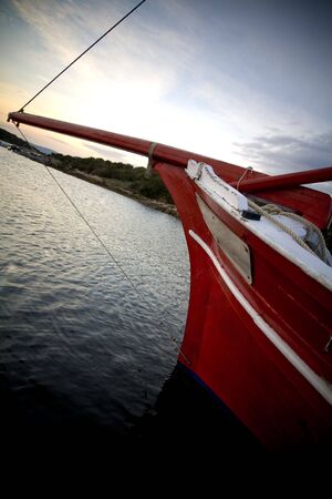 boat leaving the harbour on a cloudy dayの写真素材