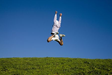 healthy lifestyle: man training outdoors and jumping highの写真素材