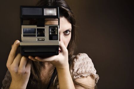 old-fashioned: girl taking a picture with an old 