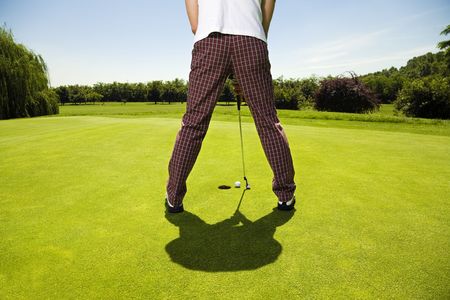Golf club: golfer concentrating on the 18th hole  