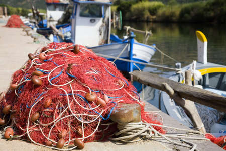 commerce and industry: red fishing nets and boats の写真素材