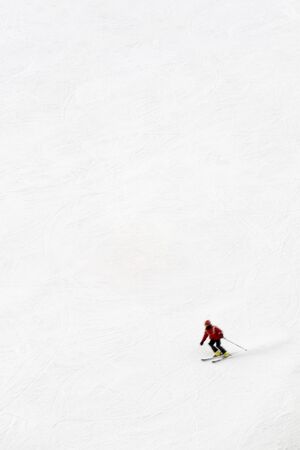 winter scene: man moving down from the top of the mountain. The skier is motion blurredの写真素材