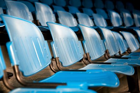 the show: rows of blue plastic chairs