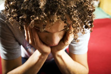 social issues: depressed guy with hands on templesの写真素材