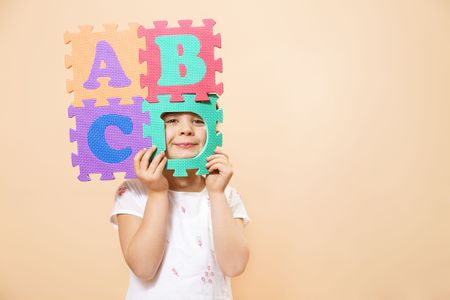 child learning the ABC's. The focus is on her eyesの写真素材