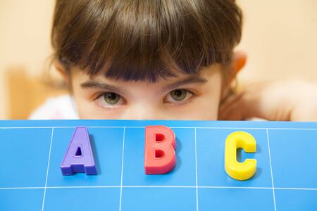 child learning the ABC's. The focus is on the lettersの写真素材