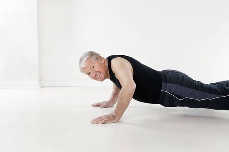 side view of senior man doing push-upsの写真素材