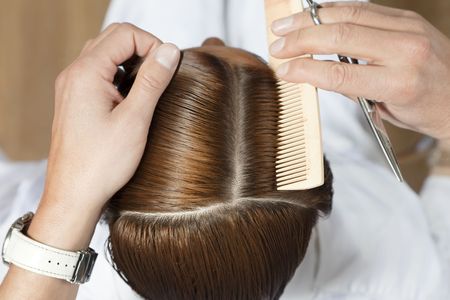 high angle view of hairdresser using combの写真素材