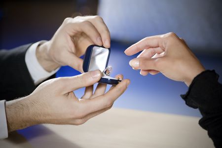 close up of young couple getting engaged. Copy space