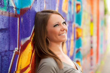 young woman in love leaning on wall and looking up. Copy spaceの写真素材