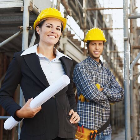 Portrait of construction worker and female architect. 