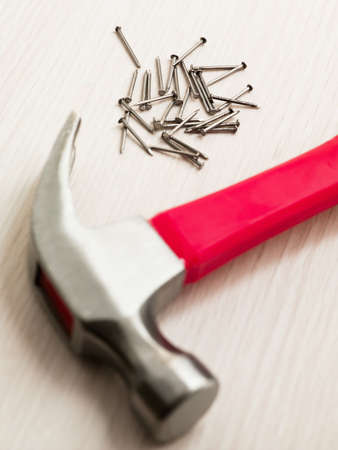 nails and hammer on wooden floor. High angle viewの写真素材