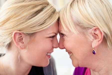 Women portrait with happy mom and daughter smiling, face to face, showing love and affection. Close upの写真素材