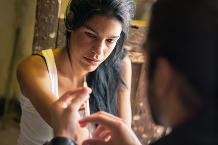 Substance abuse and people, boyfriend and girlfriend shooting up with heroin syringeの写真素材