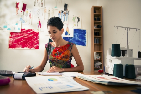 Money and financial planning, young hispanic self-employed woman checking bills and doing budget...
