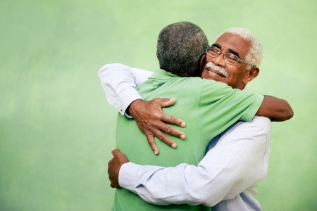 Active retired old men and leisure, two senior black brothers hugging outdoorsの写真素材