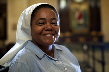 portrait of catholic nun praying in churchの写真素材