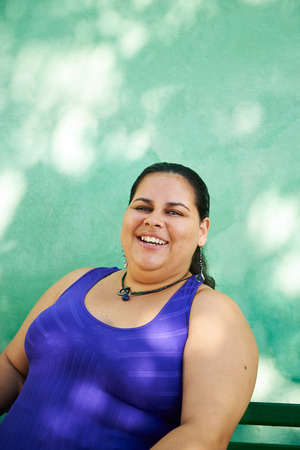 Portrait of overweight hispanic woman looking at camera and smilingの写真素材