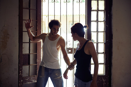 People, substance abuse and domestic violence. Drunk man hurting and hitting his young wife at homeの写真素材