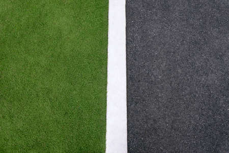 high angle view of lane and grass on roadside. Concept of environmental conservation, ecology, hard and soft surfaces. Copy spaceの写真素材