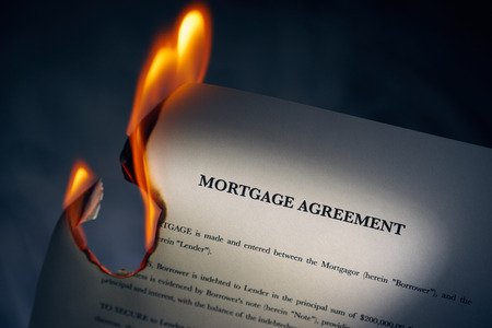 Closeup of morgage loan agreement burning. Concept shot of freedom from debts and new beginningsの写真素材
