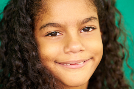 Portrait of Cuban children with emotions and feelings. Black young girl from Havana, Cuba smiling,...