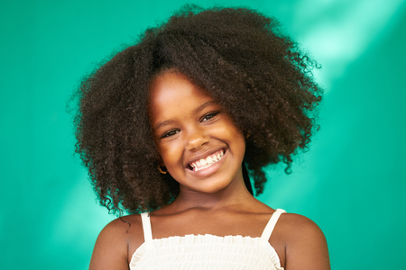 Portrait of Cuban children with emotions and feelings. Black young girl from Havana, Cuba smiling,...