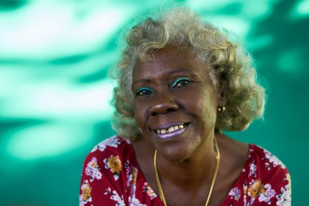Old hispanic real people from Cuba with feelings and emotions, portrait of bizarre senior african american lady smiling, laughing and looking at camera.の写真素材
