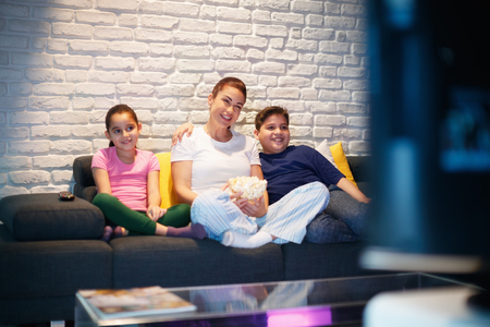 Single Mother And Children Watching TV At Nightの写真素材