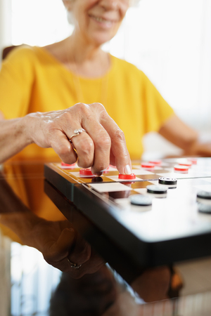 Grandma Playing Checkers Board Game In Hospiceの写真素材